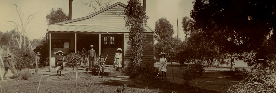 School garden, Timmering East State School No. 2177, VPRS 14562/P12 Unit 2 Black and white photo of people in front of farmhouse